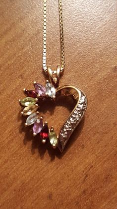 This is a gorgeous vintage sterling silver gold overlay multistone heart pendant on an Italian sterling silver gold overlay necklace. The pendant has aquamarine, amethyst,  red garnet, peridot, and citrine gemstones. The pendant and necklace are both in excellent vintage condition. The pendant measures 1 inch high by 1/2 Inch wide and the necklace measures 18 inches long. Marked Italy 925. Heart Cut Gemstone Jewelry For Mother's Day, Mother's Day Gemstone Heart Cut Jewelry, Mother's Day Heart Cut Gemstone Jewelry, Anniversary Heart Pendant Jewelry With Gemstone, Valentine's Day Gemstone Pendant Jewelry, Multicolor Hallmarked Necklace For Anniversary, Vintage Pendant Jewelry As Gift For Mom, Dainty Multicolor Jewelry For Valentine's Day, Heart Cut Jewelry For Valentine's Day Collectibles