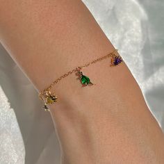 They may be petite, but they have a big RAWR! Shop our Dino Rawr Bracelet! This is so fun and adds so much color to any look. We love how playful this design is! 18k gold plated, 18k rose gold plated, or rhodium plated over brass with a protective coating Cubic zirconia stones 6" chain with a 1.5" extension 7mm charm l Playful Nickel-free Charm Bracelet For Gift, Playful Adjustable Dangle Jewelry, Adjustable Green Fun Jewelry, Fun Green Bracelets For Friendship, Fun Green Bracelet Jewelry, Playful Friendship Bracelets As Gifts, Trendy Charm Bracelet With Bracelet Strap As Gift, Trendy Charm Bracelet As A Gift, Adjustable Novelty Jewelry