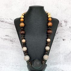 This long bohemian style necklace was hand beaded using a mix of wooden beads in sizes ranging from 10-45mm round.  This necklace features a beautiful ombre color effect, with shades of cream, sand, tan, mocha, chocolate brown, greige, soft gray, and black (a MAJOR 45mm round wooden focal bead).  A truly fresh and modern design!  The necklace measures approximately 29 inches in length and is securely fastened with a sterling silver toggle clasp.  Perfect for any gender!  Length can be adjusted i Cheap Brown Wooden Beaded Necklace, Bohemian Long Necklace With Wooden Beads As A Gift, Bohemian Wood Necklaces Perfect For Gifts, Festival Necklace With Round Wooden Beads, Bohemian Wood Necklace For Gift, Bohemian Brown Necklace With Wooden Beads, Handmade Brown Beaded Long Necklaces, Handmade Brown Beaded Long Necklace, Bohemian Wooden Necklace For Gift