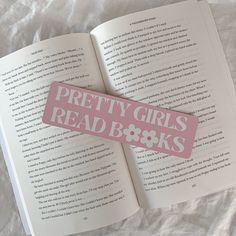 an open book with the words pretty girls read books on it's pink sticker