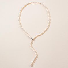 The Adjustable Pearl Lariat Necklace is approximately 27 inches in length with beautifully graduated freshwater pearl gemstones. The pearls are 7mm with the end steadily increasing to larger 10mm pearls. The sterling silver clasp allows you to adjust the graduated strand to a length unique to you. The strand can also be worn down the back to accent that backless dress or as a perfect bridal ensemble. Elegant Long Lariat Necklace For Formal Occasions, Adjustable Pearl White Lariat Necklace, Adjustable Lariat Pearl White Necklace, Elegant Pearl White Lariat Jewelry, Elegant Lariat Pearl Necklace For Formal Occasions, Elegant Pearl Lariat Backdrop Necklace, Classic Pearl Chain Lariat Necklace For Formal Occasions, Elegant Pearl Pendant Lariat Necklace, White Pearl Lariat Necklace