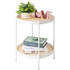 a white shelf with books and plants on it next to a planter that says love