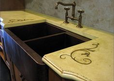 a kitchen sink with two faucets on the counter