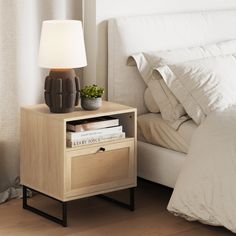 a nightstand with a lamp and books on it next to a bed in a bedroom