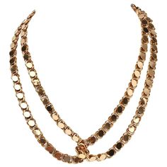 This 19 karat gold handmade gold can be worn in a variety of ways It is long enough to be wrapped around the neck two; three or four times. It can also be tied as a lariat. The necklace is a richly colored gold. It does not have a clasp. The links consist of overlapping double circles topped with an oval set on a diagonal which is an unusual design. The necklace weighs a substantial 120 grams. Luxury Multi-strand Gold Necklace, Luxury Gold Multi-strand Necklace, Gold Lariat Long Necklace, Luxury Gold Long Necklace, Gold Lariat Necklace With Adjustable Chain For Party, Gold Metal Lariat Necklace For Party, Adjustable Gold Lariat Necklace For Party, Gold Single Strand Jewelry For Evening, Single Strand Gold Jewelry For Evening