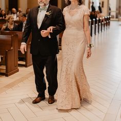 a man and woman are walking down the aisle at a wedding ceremony in an old church