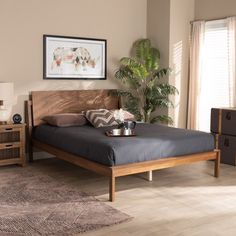 a bed room with a neatly made bed and two nightstands next to each other