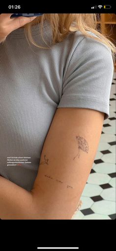 a woman with a tattoo on her arm