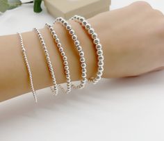 Sterling silver stretch bracelet beaded with Sterling silver 2mm,3mm,4mm, 5mm and 6mm beads. Great to wear alone or layered with other beaded bracelets. Bracelet measuring about 7inches with stretch. *Price is for one Bracelet. Add initials below  https://etsy.me/3IWjMIp All Jewelry is personalized and packaged in our small studio 🤍 * Order are shipped out 1-3 business days after the order as been received. If you need your order faster please upgrade at checkout * ** shipping ** All jewelry is packaged in anti tarnish plastic bags and neatly packed in a box or a gift bag and ready to gift. If you need extra gift boxes leave us a message at checkout ** Returns ** Returns can be made within 14 days of receiving your order. We will provide you with instructions on mailing your package back. Personalized Silver Bracelets, Goddaughter Gifts, Monogram Bracelet, Bracelet Initial, Minimalist Women, Custom Bracelet, Jewelry Personalized, Initial Bracelet, Custom Bracelets