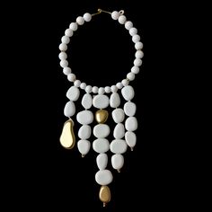 This elegant choker necklace measures 16 inches, complemented by a striking strand of beads that extends to 28 inches.   Featuring dangling acrylic white beads adorned with gold accent beads, this versatile piece serves as a bold statement accessory suitable for both formal and informal occasions.  The pure white beads create a stunning visual impact, ensuring this necklace stands out effortlessly in any setting. Elegant White Beaded Necklaces With Large Beads, Elegant White Beaded Necklace With Large Beads, Elegant White Necklaces With Large Beads, Elegant White Necklace With Large Beads, Modern White Adjustable Necklace, White Necklace With Large Beads For Party, Adjustable White Jewelry With Dangling Beads, White Adjustable Jewelry With Dangling Beads, White Pearl Chain Choker Necklace