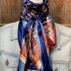 Our classic wild rag/scarf  in a blue color is accented with a multi-floral pattern. A perfect square - measuring 35"x35". Adding that extra touch of a western style to your outfit. 100% soft silk feeling polyester is durable to keep you warm in the cold and fashionable for any occasion. Plus it's machine washable!  Additional accessories are available- (Please see our slide options on our site)  *Leather slides *Western concho slides *Crystal concho slide  *Buckle slides Blue Bandana Scarf As Gift, Blue Bandana As Gift, Blue Scarves For Spring, One Size, Blue One Size Scarves For Spring, One Size Blue Scarves For Spring, Blue Silk Scarf As Gift, Bohemian Blue Bandana Scarf, Bohemian Blue Scarf Bandana, Blue Square Scarves For Gifts