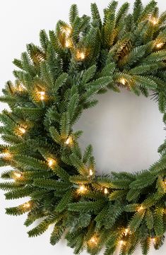 a christmas wreath with lights hanging from it