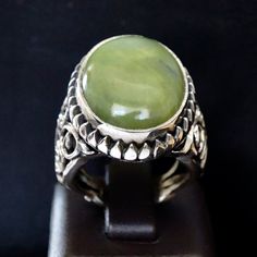 925 STERLING SILVER MEN'S RING WITH GREEN JADE Handcrafted by Turkish artisan jewelers Sterling Silver - unique design Gemstone: natural green Jade origin: Brazil Stone Dimensions: 18x25x5mm weight: 13ct Size: US10.25 *for resizing request feel free to contact. Worldwide express delivery Green Ring With Large Stone, Green Large Stone Ring Jewelry, Green Large Stone Ring, Green Oval Stone Setting Rings, Green Oval Rings With Stone Setting, Oval Green Rings With Stone Setting, Green Emerald Ring In Sterling Silver, Green Oval Rings With Natural Stones, Sterling Silver Emerald Ring With Gemstone