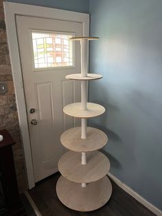 a three tiered shelf in front of a door