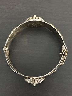 Thus Middle Eastern bracelet is so UNIQUE! It has 2 hamsas, 2 camels and 2 domes. The clasp is a pin attached to a chain that pulls out to unlatch. We are unsure of the material it is made of, but it is a nice weight; 47.7 grams. This piece is very special and will be a conversation piece, for sure. Silver Bracelet With Butterfly Clasp, Ornate Adjustable Bracelets For Ceremonial Occasions, Adjustable Antique Metal Bracelets, Adjustable Antique Metal Bracelet, Adjustable Silver Jewelry With Butterfly Clasp, Ornate Adjustable Nickel-free Bracelets, Ornate Adjustable Nickel Free Bracelet, Adjustable Chain Bracelet With Box Clasp, Ornate Adjustable Nickel-free Bracelet