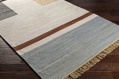 an area rug on the floor with wooden floors