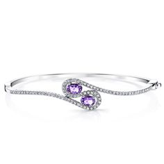 Amethyst fields Take a trip to the lavender fields of Provence with the breathtaking beauty of the Peora natural Amethyst. This classic bracelet features oval shape Peora natural Amethyst gemstones in .925 sterling silver. Our natural Amethyst gemstones are a unique gift from nature. By cutting them in a way that respects the rough's natural radiance, we ignite their inherent intensity and maximize their brilliance to deliver on our signature Peora standard. Handcrafted in pure .925 sterling silver goodness, this bracelet has been carefully coated in an elegant rhodium finish. Our artisans are expertly trained in this process which fortifies the bracelet's strength, shine and brilliance. Looking for an anniversary or engagement present? Our concierge stylists are here to help with all of y Amethyst Bangle, Jewelry Questions, Peridot Bracelet, Classic Bracelets, Expensive Jewelry, Peridot Gemstone, Bracelet Sterling Silver, Swiss Blue Topaz, Hinged Bangle