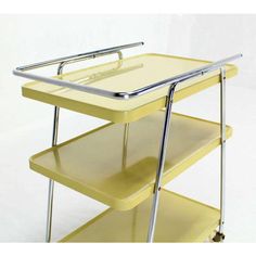 a yellow cart with two shelves on each side and one shelf attached to the back