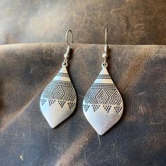 Silver Boho Dangle Earrings - Teardrop Shape with Geometric Patterns Elevate your style with our Ethnic Silver Dangle Drop Earrings, handmade from silver-plated Zamac. Perfect for everyday Boho flair and a thoughtful gift for your girlfriend. Discover comfort in Bohemian design. The unique dangle drop style adds a touch of individuality, making them a versatile choice for any occasion. The silver-plated Zamac not only ensures durability but also brings a subtle gleam to enhance your overall look. Zamac, composed of zinc, aluminum, magnesium, and copper, ensures both strength and a lightweight feel. The silver plating adds a touch of refinement, creating a captivating interplay of light and shadow. We prioritize comfort in our design, allowing you to enjoy these earrings effortlessly throug Earrings Teardrop, Bohemian Design, Bohemian Earrings, Gifts For Your Girlfriend, Geometric Patterns, Jewelry Handmade, Earrings For Women, Earrings Handmade, Thoughtful Gifts