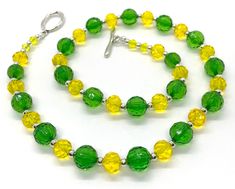 "Delicious Lightweight handcrafted 22\" necklace punches up any outfit.  Acrylic beadwork accents your wardrobe with creativity and color. This sparkly lemon-lime  light-hearted necklace is both classic and contemporary. A breath of spring any time of the year!  Refresh that outfit and make it new again!" Green Large Beads Necklace For Party, Green Single Strand Jewelry For Party, Single Strand Green Jewelry For Party, Adjustable Yellow Single Strand Beaded Necklaces, Adjustable Single Strand Yellow Beaded Necklaces, Adjustable Yellow Single Strand Beaded Necklace, Adjustable Single Strand Yellow Beaded Necklace, Summer Party Jewelry With Faceted Beads, Green Beaded Necklaces With Large Beads For Summer