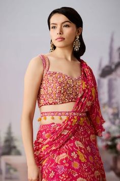 Fuchsia pre-draped ruffle saree with floral chintz printed base. Comes with embroidered padded blouse, embellished by beads and sequins. Paired with jewel embellished belt. - Aza Fashions Pink Sleeveless Pre-draped Saree For Diwali, Traditional Pink Draped Lehenga, Traditional Draped Pink Lehenga, Draped Pallu Dress For Festivals, Pink Ruffled Choli For Navratri, Festival Draped Dress With Pallu, Pink Traditional Drape Blouse For Summer, Pink Pre-draped Saree For Summer, Fitted Draped Pink Set