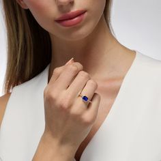 This ageless design inspired by the Art Deco era showcases a striking and brilliant emerald cut sapphire that rests within a smooth bezel setting. Twinkling diamonds cascade downwards along the shank, adding a touch of sparkle that shimmers with each movement. We love this classic yet modern style worn solo for a lasting impact. Metal: 18kt Gold Sapphire Weight: 1.50 ct. Diamond Weight: 0.08 ct. Measurements: 7.0 mm length *Please note that the listed ct. weights are approximate and may be subje Diamond Bezel Ring, Alexandrite Ring, Bezel Ring, Art Deco Era, Sapphire Jewelry, Bezel Diamond, Engagement Ring Wedding Band, Ring Size Guide, High Jewelry