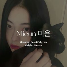 a woman holding a black cat in her hands with the caption mean meow beautiful grace organ korean