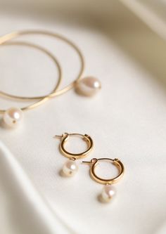 An everyday classic. Polished pearl hoops to give you a classic modern look. • Available in 14k gold filled • Available in 15mm or 18mm hoops • Made in United States Classic Round Pearl Earrings For Everyday, 14k Gold-filled Huggie Hoop Earrings With Pearl Charm, Classic 14k Gold Filled Hoop Earrings For Everyday Luxury, 14k Yellow Gold Filled Round Pearl Earrings, Timeless Round Pearl Earrings For Everyday, Classic Everyday Pearl Drop Jewelry, Minimalist Round Huggie Earrings, Minimalist Everyday Elegance Huggie Earrings, Everyday Pearl Charm Huggie Jewelry