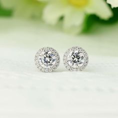 Showcased here is classic round halo studs earrings.  Center set in round cut 1.0ct.  There are also small stone halo set around the center stone.  Great gift for yourself or for friends! ITEM SPECIFICATIONS: Metal Type: Solid 925 Sterling Silver Metal Stamp: 925 Plating: Rhodium  Main Stone Dimensions: Round 6.5mm Approximate Center stone: 1 Carat (each) Approximate Carat Total Weight (CTW): 1ct cener, 1.16 carat total per pc (in par 2.32 Carat Total) Dimension:  Dimension with Halo approx. 10m Wedding Silver, Round Halo, Travel Jewelry Box, Mixed Metal Jewelry, Earring Organizer, Halo Earrings, Halo Earrings Studs, Diamond Simulant, Earrings Wedding