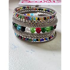 This Wrap Bracelet features colorful beads and an oxidized finish. The unique design allows for versatility in styling, adding a touch of color and texture to any outfit. Crafted with high-quality materials, it is a must-have accessory for any fashion-forward individual. One size fits all. Metal Beaded Bracelets For Festival, Trendy Metal Beaded Bracelets, Multicolor Bohemian Beaded Bracelets With Silver Beads, Bohemian Silver Crystal Bracelet With Colorful Beads, Bohemian Multicolor Bracelets With Silver Beads, Multicolor Metal Beaded Bracelets, Multicolor Beaded Cuff Bracelet For Festivals, Green Beaded Metal Bangle Bracelets, Trendy Beaded Chain Bracelets For Party