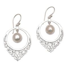 This exquisite pair of earrings is designed and crafted by Balinese artisan Suar Dwipayana. The drop-shaped sterling silver setting features an intricate motif of heart-shaped vines. Dangling gracefully inside its circular confines a dazzling cultured mabe pearl comes to life with every sway and movement while a combination finishes adds a beautiful visual depth. Ornate Sterling Silver Teardrop Earrings For Gift, Ornate Sterling Silver Teardrop Earrings As Gift, Pierced Teardrop Pearl Earrings In Sterling Silver, Bohemian Sterling Silver Pearl Drop Jewelry, White Teardrop Earrings With Intricate Design, Bohemian Sterling Silver Jewelry With Pearl Drop, Sterling Silver Teardrop Earrings With Intricate Design, Sterling Silver Intricate Teardrop Earrings, Intricate Design Round Pearl Earrings Gift