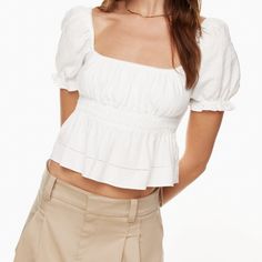 This Is A Smocked Peplum Blouse With Puff Sleeves That Can Be Worn On Or Off The Shoulder. It’s Made With Lightweight 100% Organic Cotton. Fit: Classic Follows Your Contours With A Little Room Length: Waist Intended To Hit Between The Waist And High Hip A Size L Will Fit Someone Who Typically Wears A 12 In Other Aritzia Clothing. Depending On Body Shape And Fit Preference, A L May Also Fit Someone Who Wears A 10 Or 14. Bust 39 In 40 1/2 In Waist 31 1/2 In 33 1/4 In Solid Color Puff Sleeve Tops With Smocked Back, Solid Color Tops With Smocked Back And Puff Sleeves, Feminine Tops With Gathered Sleeves And Square Neck, Feminine Tops With Square Neck And Gathered Sleeves, Chic Peasant Top With Smocked Bodice, Chic Smock Top With Square Neck, Casual Puff Sleeve Top With Square Neck, Summer Tops With Gathered Sleeves And Square Neck, Chic Smock Blouse For Day Out