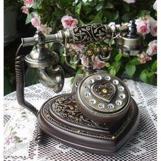 an old fashioned phone sitting on top of a table