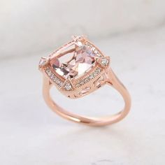 This Luxoro 10K rose gold ring for women features a AAA Marropino morganite gemstone in a halo design, symbolizing eternal love and commitment. The cushion-shaped morganite centerpiece, encircled by round diamonds, is finely and skillfully cut for captivating sparkle and durability. Gold Ring For Women, Morganite Gemstone, Halo Design, Tanzanite Diamond, Gold Chain Jewelry, Morganite Ring, Signature Jewelry, Cross Jewelry, Size 10 Rings