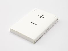 a white book with a cross drawn on it