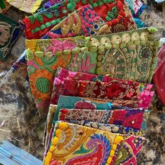 many colorful pieces of cloth are on the table