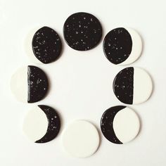 six black and white moon magnets arranged in a circle