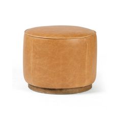 a tan leather stool with wooden legs and an ottoman on the bottom, in front of a white background