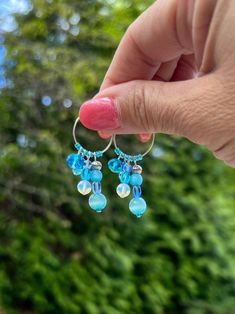 "These whimsical, hand crafted, one of a kind earrings are made with silver plated copper wire hoops with aqua blue glass beads and mother of pearl beads.  Assorted beads dangle from the beaded hoops, adding shimmer to the unique earrings.  They sparkle in the sun adding a touch of fun to your look!  All earring hooks are made of high quality material, nickel-free, Hypo-allergenic, safe and durable.  Earrings are approximately 2\" long. The beautiful bohemian/hippie style multi-toned earrings wo Handmade Blue Beaded Small Hoop Earrings, Blue Beaded Small Hoop Earrings, Blue Dangle Hoop Earrings, Blue Small Hoop Beaded Earrings With Dangling Beads, Blue Beaded Hoop Earrings Gift, Handmade Small Hoop Blue Earrings, Blue Small Hoop Jewelry With Dangling Beads, Blue Small Hoop Wire Wrapped Earrings, Blue Small Hoop Earrings Wire Wrapped