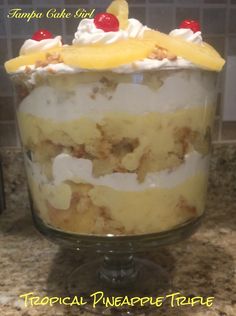 a dessert in a glass dish with pineapples on top and whipped cream around the edges