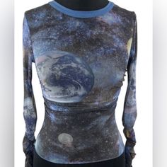 This Women's Urban Outfitters Blue Galaxy Mesh Top Is Perfect For A Night Out On The Town. It Is Made Of A Soft And Stretchy Mesh Fabric That Is Comfortable To Wear. The Top Features A Unique Galaxy Print With Stars, Planets, And Moons. It Has A Slim Fit And Is Cropped At The Waist. The Sleeves Are Long And Have A Ruffled Hem. The Top Is In Excellent Condition And Has Only Been Worn Once. Y2k Style Stretch Blue Tops, Fitted Blue Y2k Tops, Fitted Blue Y2k Style Tops, Fitted Y2k Blue Tops, Trendy Fitted Blue Tops, Urban Outfitters Blue Graphic Print Tops, Blue Y2k Crop Top, Urban Outfitters Blue Tops With Graphic Print, Trendy Fitted Blue Crop Top