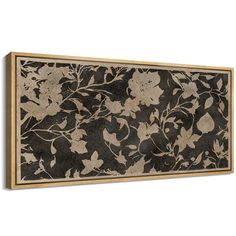 a black and gold floral wall hanging on a white wall