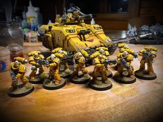 some yellow and black warhammers on a table