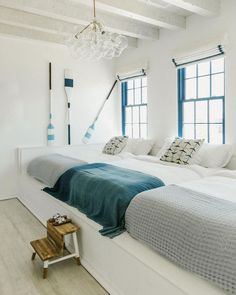 two beds in a room with white walls and wooden floors