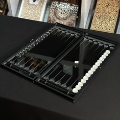 a black table topped with two mirrors and candles