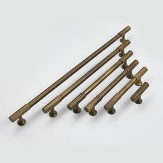 six antique brass cabinet pulls on a white background