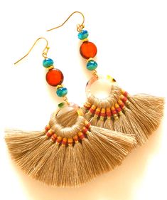 "Summery woven fan tassel earrings in sandy beige with burnt orange and aqua Czech glass accents. Tan fan tassels are woven with orange accents on acetate rings. Measure 70 x 45mm. Burnt orange Picasso coin beads and Mykonos aqua blue Czech glass beads add fun colors. Earrings hang from gold plated French hooks. Total length is 3 1/2\". Lightweight and summery!" Bohemian Orange Tassel Earrings For Party, Orange Tassel Earrings, Bohemian Orange Earrings, Bohemian Orange Czech Glass Earrings, Bohemian Orange Tassel Earrings, Paris Charm Bracelet, Orange And Aqua, Orange Accents, Gifts For An Artist