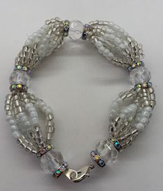 "Handmade Obatala inspired bracelet, made with high quality glass beads. Obatala is the eldest of the orishas in santeria and the king of the religion in orun (heaven). He is also the father of many of the orishas and as such is given great respect and deference by the other orishas in matters of great importance. Colors: White Numbers: 8 Catholic saint: Our Lady of Mercy Item made to order. Will measure approximately 7.5\" unless you request a different size. *All items purchased will be saged Adjustable Silver Beads Spiritual Rosary Bracelet, Adjustable Spiritual Rosary Bracelet With Silver Beads, Spiritual Beaded Bangle Bracelets With Spacer Beads, Spiritual Czech Glass Bracelet Jewelry, Spiritual Czech Glass Bracelet, Adjustable Spiritual Silver Beaded Bracelets, Silver Adjustable Bracelets With Oval Beads, White Spiritual Bangle Jewelry, Spiritual Czech Glass Bracelets With Large Beads