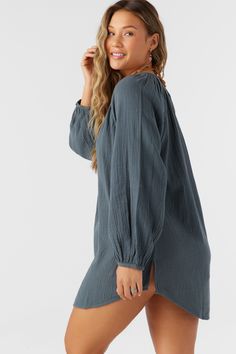 A flowy cover-up dress that has a relaxed long sleeve design and mini length fit. O'Neill Women's woven cover-up 28" In length Front button closure Solid color wash Lightweight, breathable fabrication 100% Cotton Crinkle Double Gauze Chic Long Sleeve Cover-up For Daywear, Relaxed Fit Long Sleeve Top For Beach Cover-up, Chic Long Sleeve Loungewear Cover-up, Summer Long Sleeve Tunic For Brunch, Summer Long Sleeve Tops With Crinkle Texture, Long Sleeve Beachwear Cover-up For Brunch, Spring Breezy Cover-up With Long Sleeves, Long Sleeve Summer Tops With Crinkle Texture, Breezy Long Sleeve Spring Cover-up