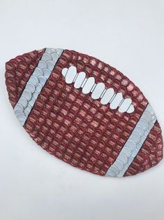 a close up of a football on a white surface with red and grey lines around it